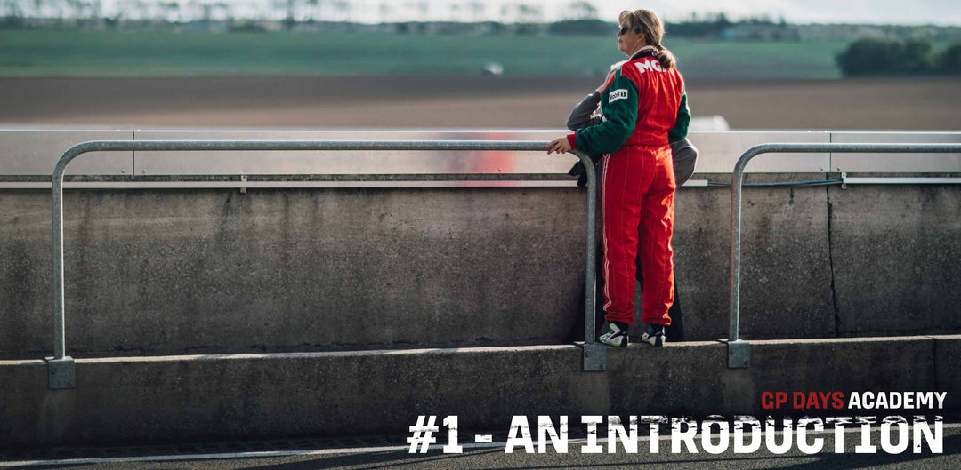 A woman is standing at a Track Day looking at the GP Days Track Day