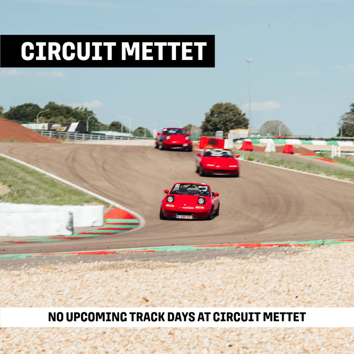 Several Mazda MX5 racing through the Cork Screw corner at Circuit Mettet during a GP Days Open Pitlane Track Day